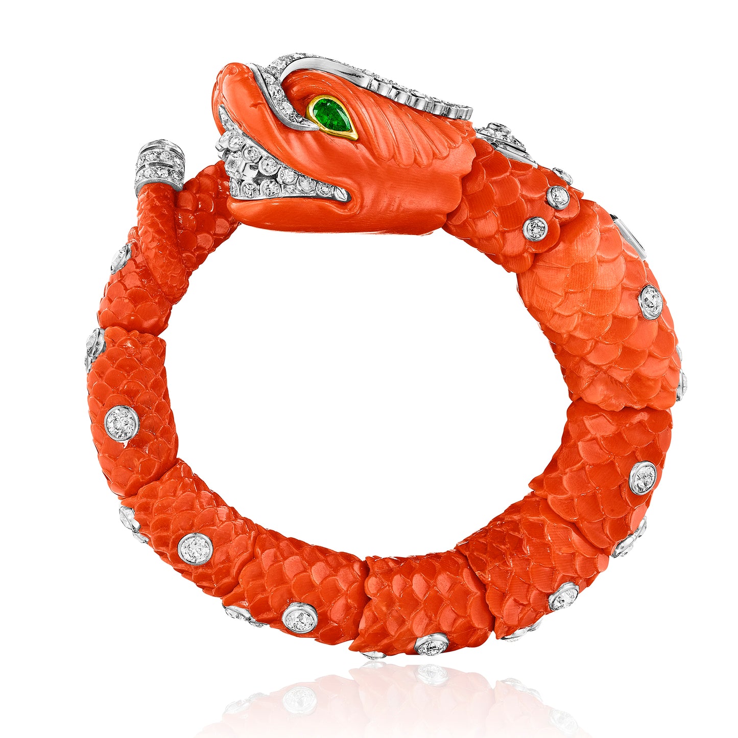 CARVED CORAL, EMERALD, AND DIAMOND CHIMERA BANGLE BY CARTIER, PARIS, CIRCA 1960