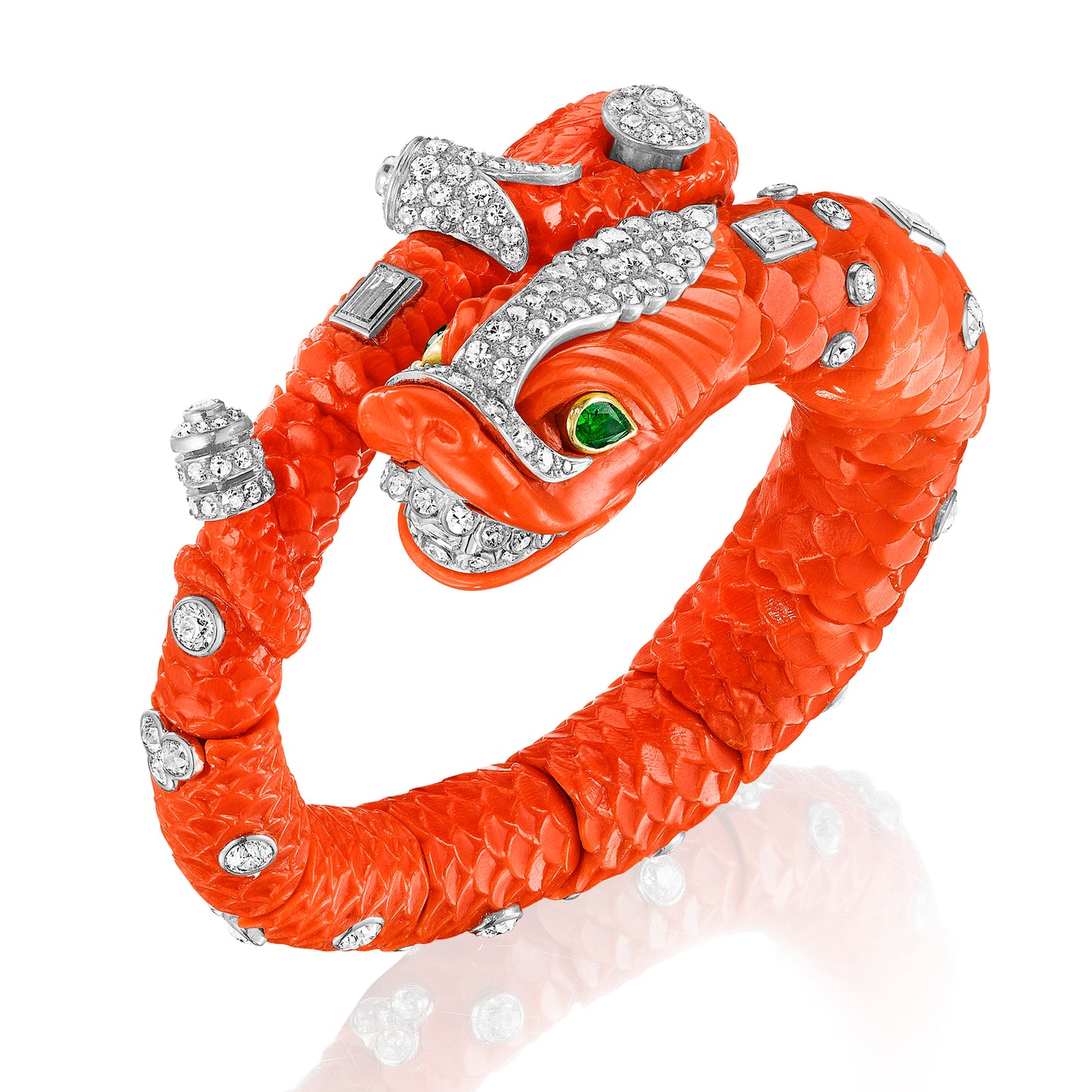 CARVED CORAL, EMERALD, AND DIAMOND CHIMERA BANGLE BY CARTIER, PARIS, CIRCA 1960