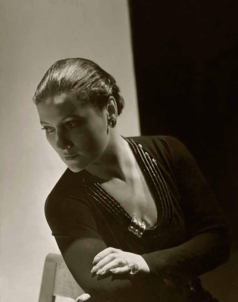 Suzanne Belperron photographed by Horst P. Horst for Vogue, 1934, wearing a single clip brooch of her own design.