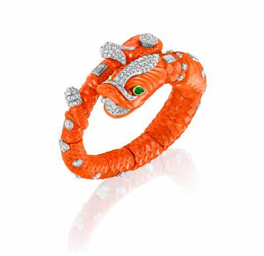 CARVED CORAL, EMERALD, AND DIAMOND CHIMERA BANGLE BY CARTIER, PARIS, CIRCA 1960